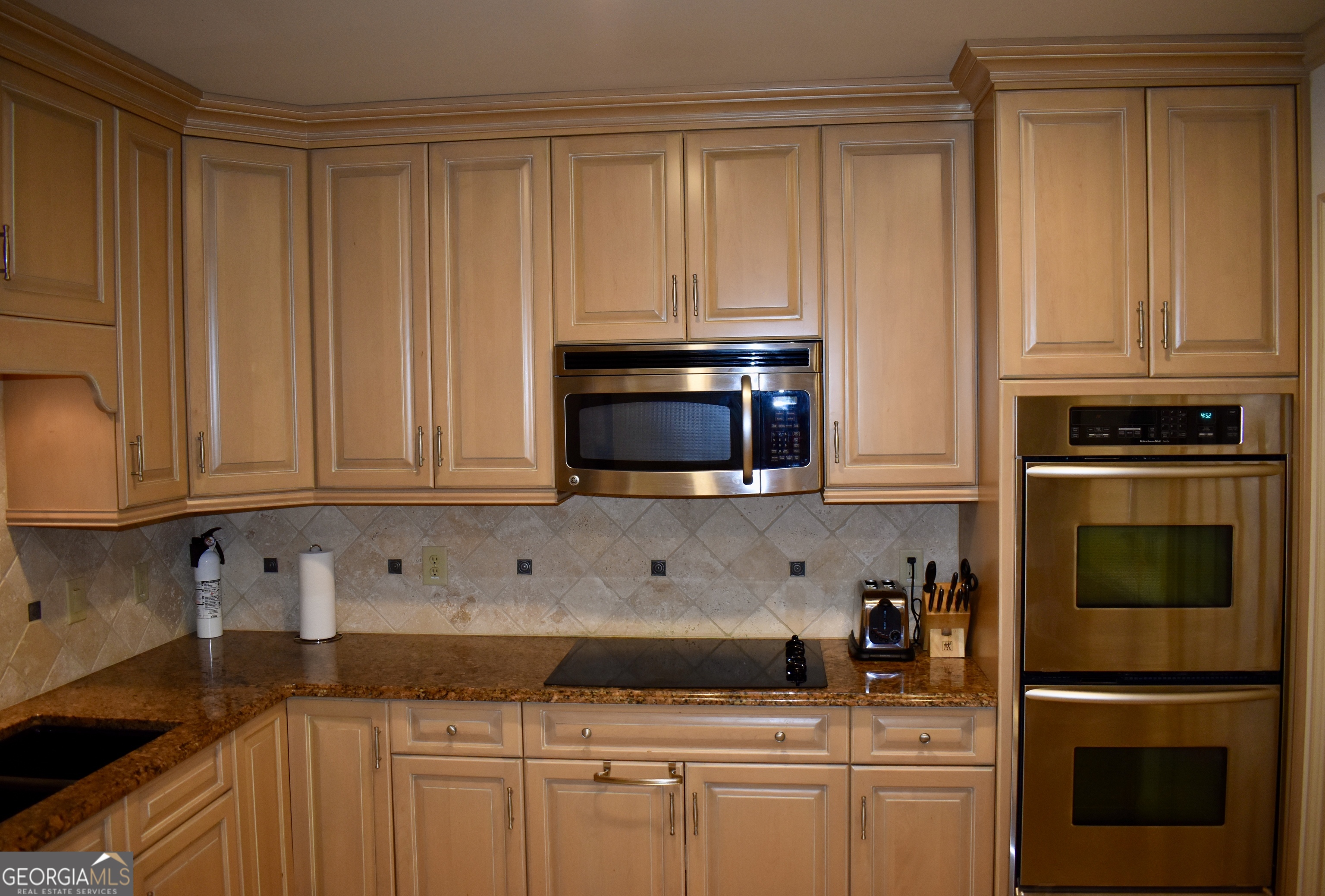 3 Club Drive Newnan, GA 30263 - Photo 16 of 43 a kitchen with stainless steel appliances granite countertop a stove a microwave and cabinets