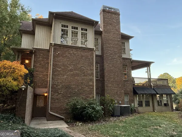 a front view of a house with plants