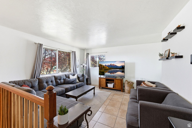 2632 North 140 West Sunset, UT 84015 - Photo 2 of 12 Living area featuring light tile patterned floors and a textured ceiling
