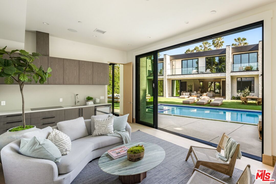17055 Rancho Street Encino, CA 91316 - Photo 47 of 73 a living room with furniture and a potted plant