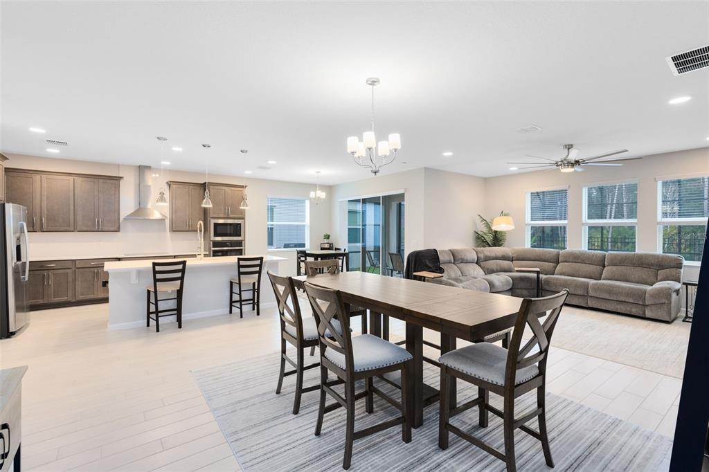 5229 Prairie Preserve Run St. Cloud, FL 34772 - Photo 13 of 36 a view of a dining area with furniture and chandelier