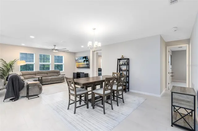 a view of a dining room with furniture and window