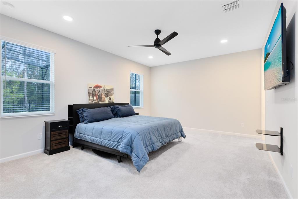 5229 Prairie Preserve Run St. Cloud, FL 34772 - Photo 17 of 36 a bedroom with a bed window and a flat screen tv