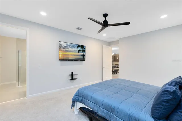 a bedroom with a bed and a painting on the wall