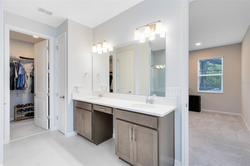 5229 Prairie Preserve Run St. Cloud, FL 34772 - Photo 19 of 36 a bathroom with a sink and a mirror