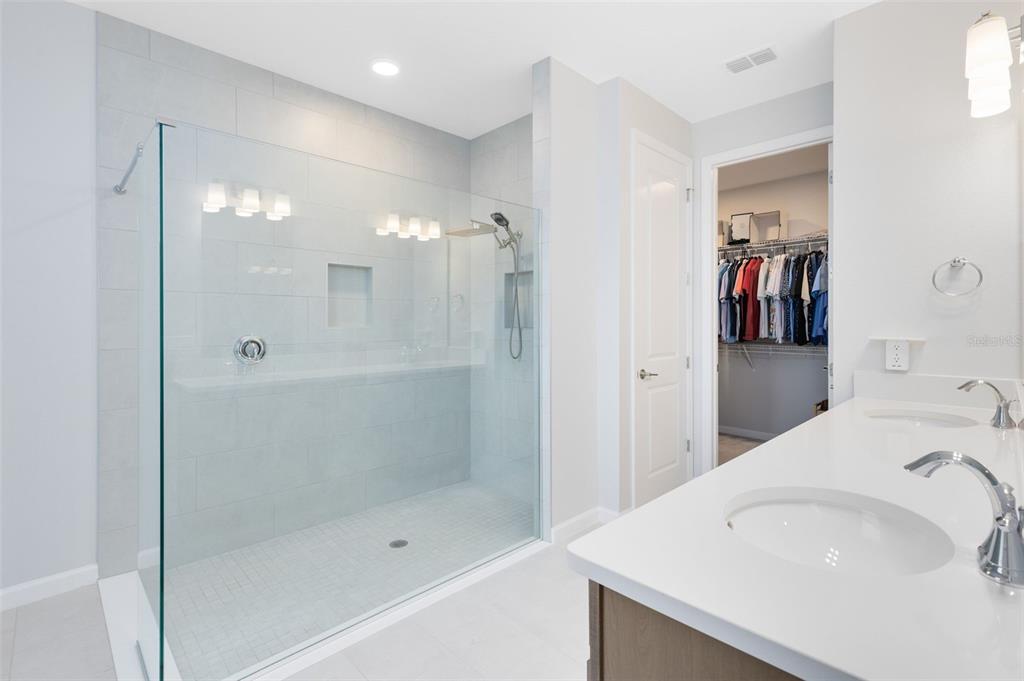 5229 Prairie Preserve Run St. Cloud, FL 34772 - Photo 20 of 36 a bathroom with a bathtub and a shower