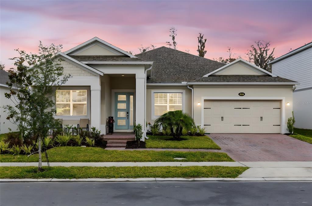 5229 Prairie Preserve Run St. Cloud, FL 34772 - Photo 2 of 36 a front view of a house with a yard