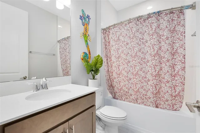 a bathroom with a sink toilet and mirror