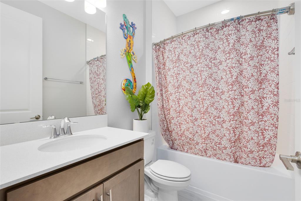 5229 Prairie Preserve Run St. Cloud, FL 34772 - Photo 23 of 36 a bathroom with a sink toilet and mirror