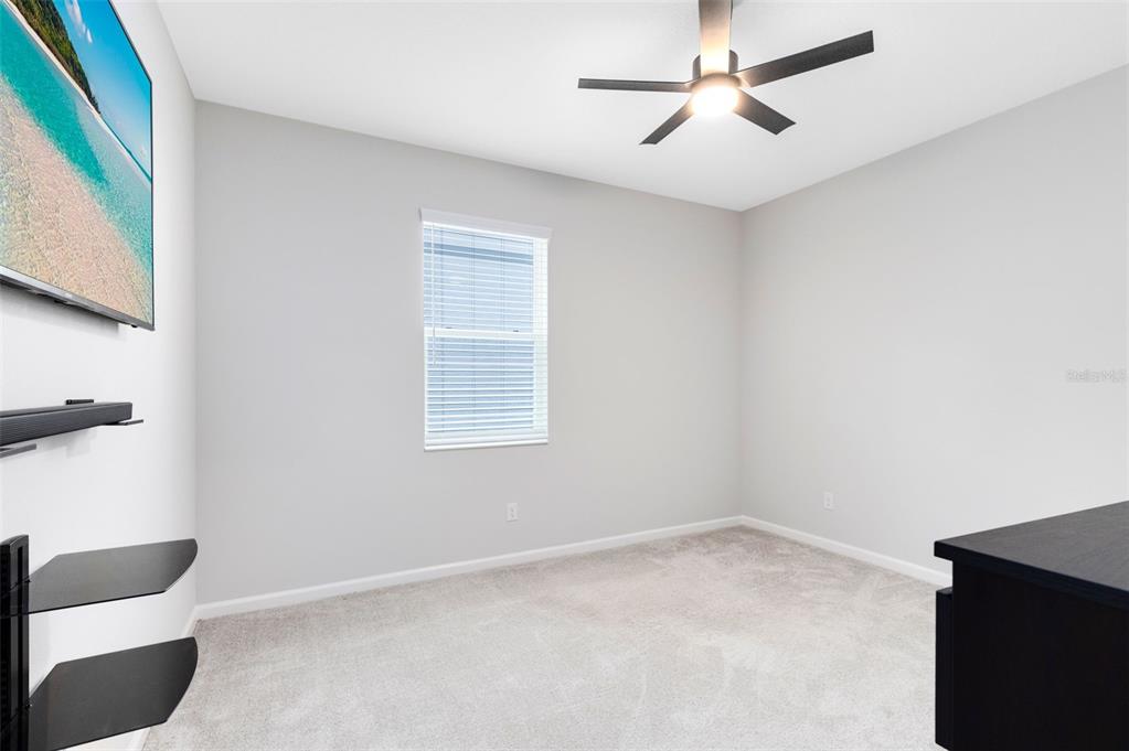 5229 Prairie Preserve Run St. Cloud, FL 34772 - Photo 24 of 36 a view of an empty room with a ceiling fan and a window