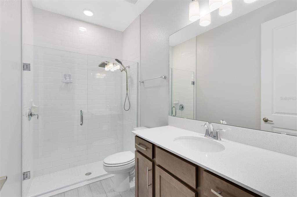 5229 Prairie Preserve Run St. Cloud, FL 34772 - Photo 26 of 36 a bathroom with a sink a toilet and shower