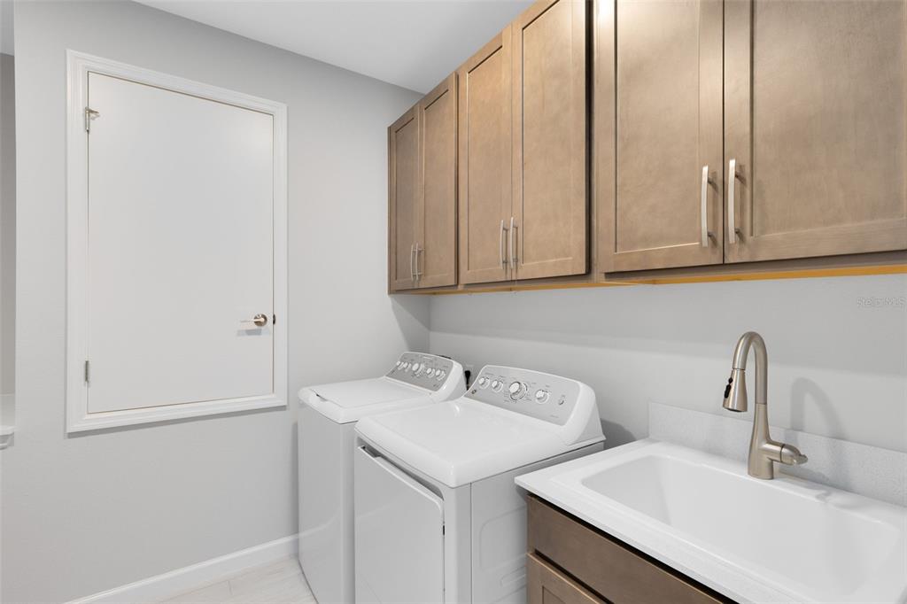 5229 Prairie Preserve Run St. Cloud, FL 34772 - Photo 27 of 36 a bathroom with a sink and cabinets