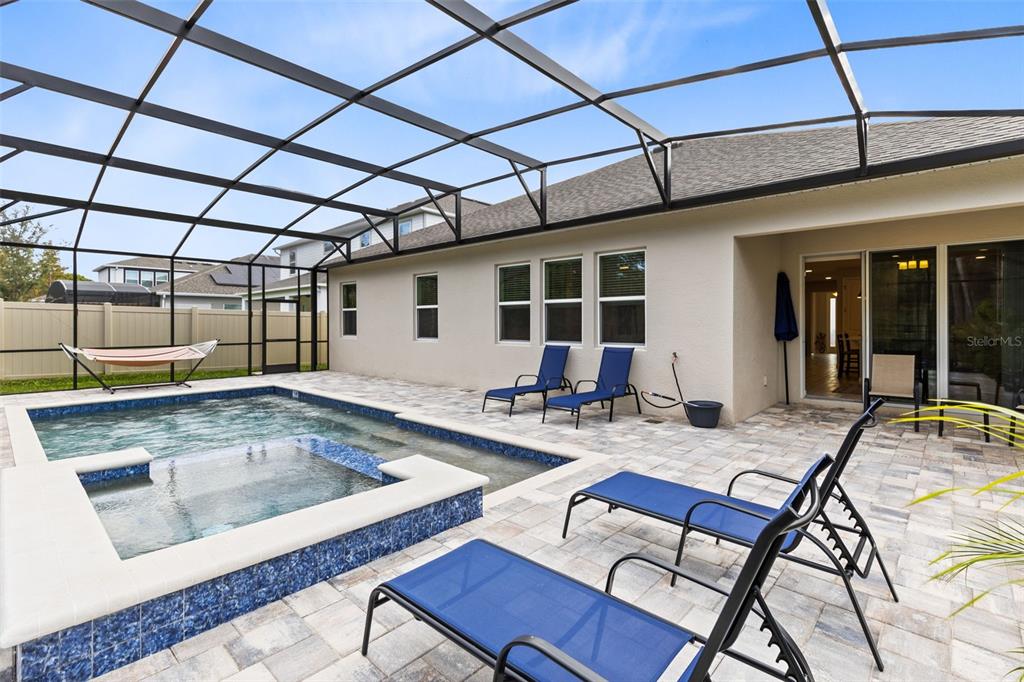 5229 Prairie Preserve Run St. Cloud, FL 34772 - Photo 28 of 36 a outdoor patio with swimming pool table and chairs