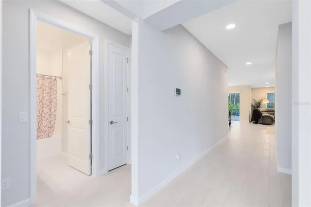 a view of a hallway with wooden floor