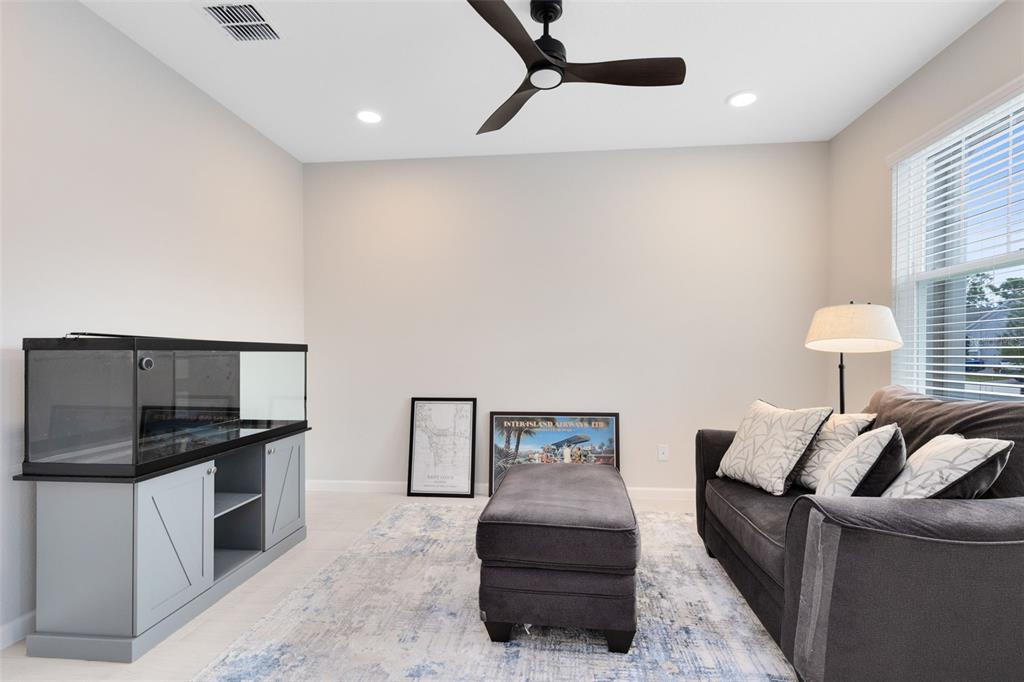 5229 Prairie Preserve Run St. Cloud, FL 34772 - Photo 7 of 36 a living room with furniture and a flat screen tv