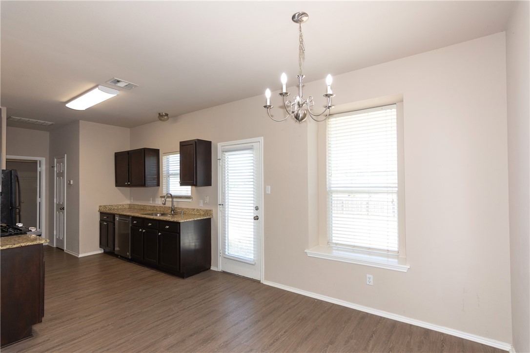 2605 Summerwalk Place Round Rock, TX 78665 - Photo 12 of 37 a view of a kitchen with granite countertop stainless steel appliances and wooden floor
