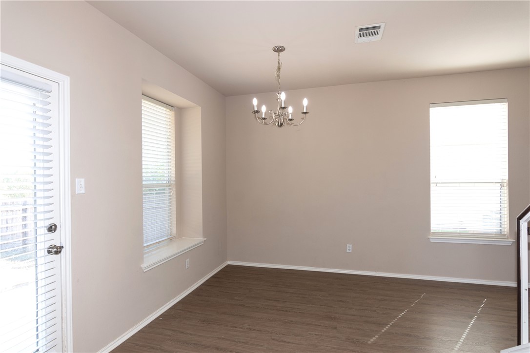 2605 Summerwalk Place Round Rock, TX 78665 - Photo 13 of 37 an empty room with wooden floor and windows