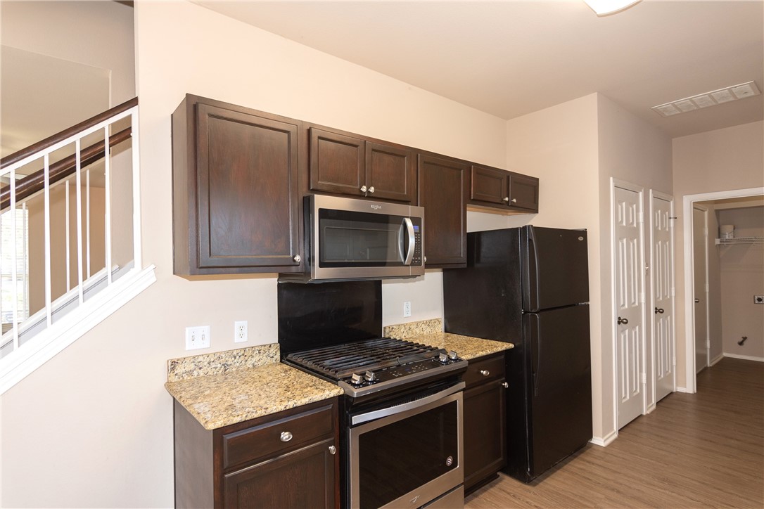 2605 Summerwalk Place Round Rock, TX 78665 - Photo 16 of 37 a kitchen with a stove microwave and refrigerator