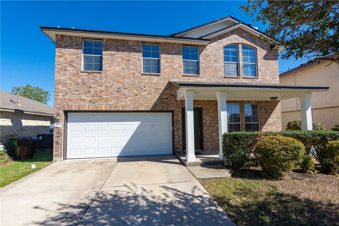 2605 Summerwalk Place Round Rock, TX 78665 - Photo 2 of 37 a front view of a house with a yard and garage