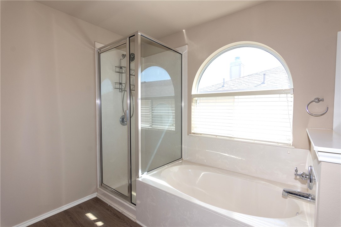 2605 Summerwalk Place Round Rock, TX 78665 - Photo 21 of 37 a bathroom with a tub a sink and a window