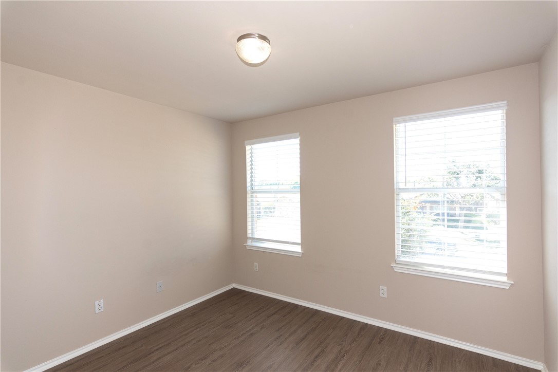 2605 Summerwalk Place Round Rock, TX 78665 - Photo 23 of 37 an empty room with wooden floor and windows