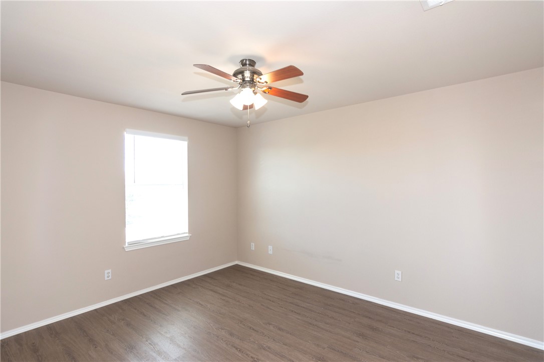 2605 Summerwalk Place Round Rock, TX 78665 - Photo 25 of 37 an empty room with wooden floor fan and windows