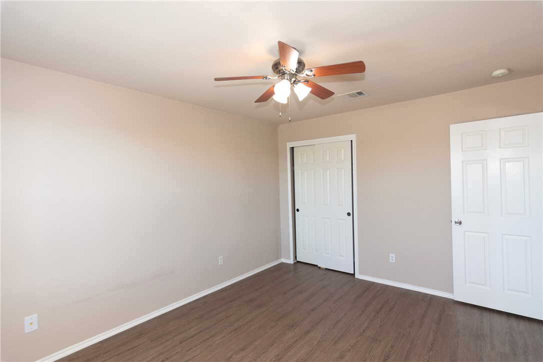 2605 Summerwalk Place Round Rock, TX 78665 - Photo 26 of 37 an empty room with wooden floor fan and windows