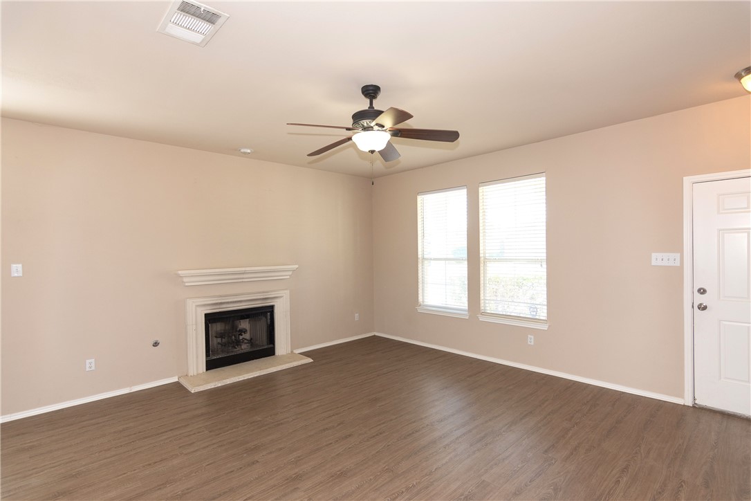 2605 Summerwalk Place Round Rock, TX 78665 - Photo 3 of 37 an empty room with chandelier fan and wooden floor