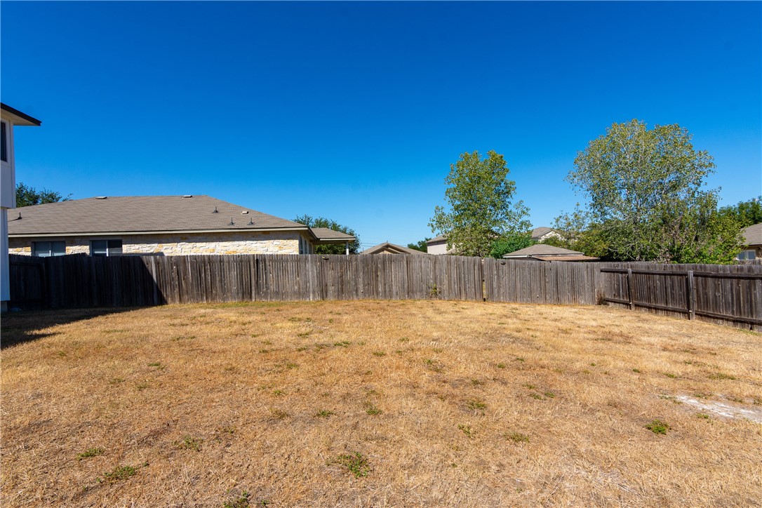 2605 Summerwalk Place Round Rock, TX 78665 - Photo 36 of 37 a backyard of a house with wooden fence