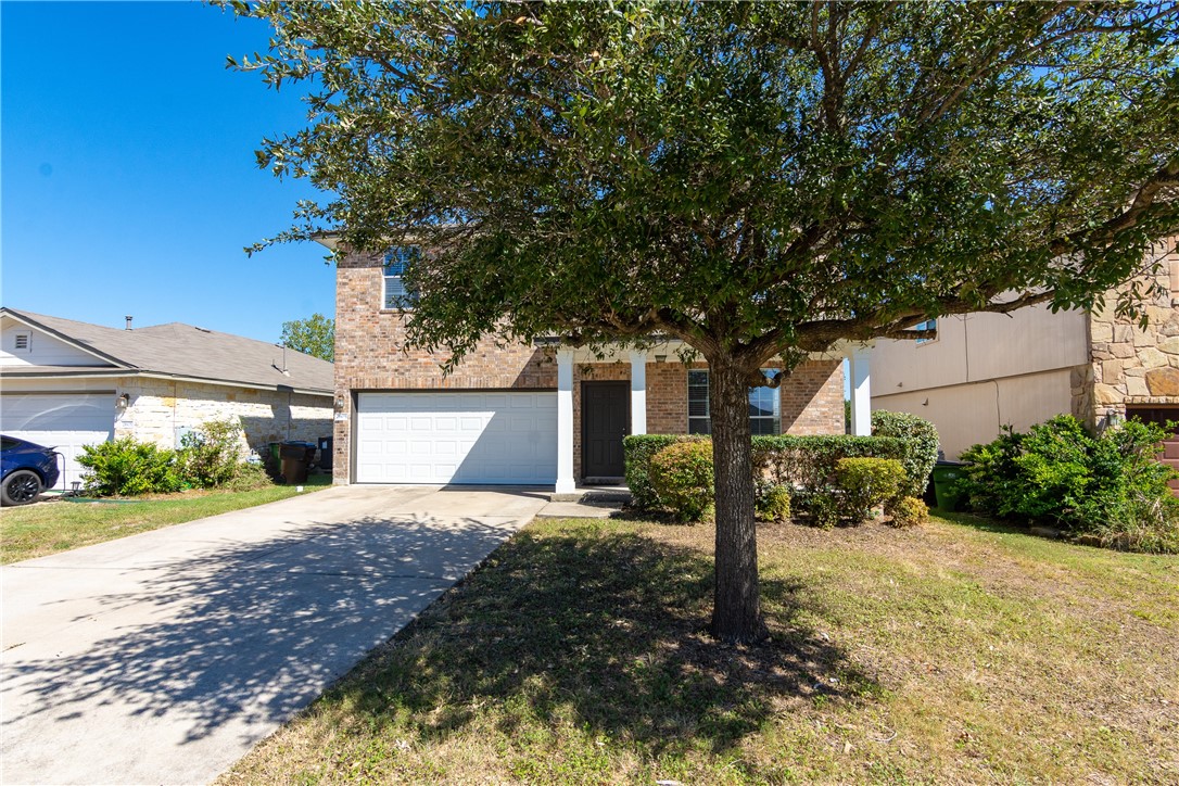 2605 Summerwalk Place Round Rock, TX 78665 - Photo 6 of 37 a front view of a house with a yard and garage