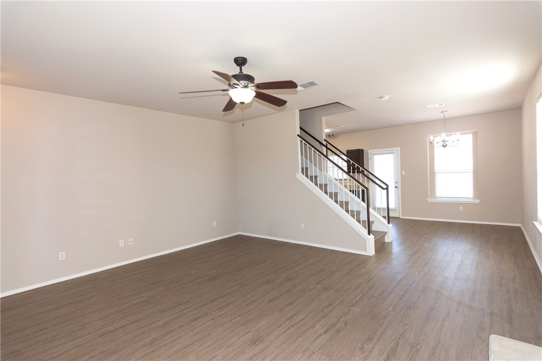 2605 Summerwalk Place Round Rock, TX 78665 - Photo 10 of 37 a view of empty room with wooden floor and fan