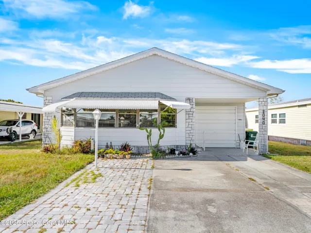 a view of a house with backyard porch and sitting area