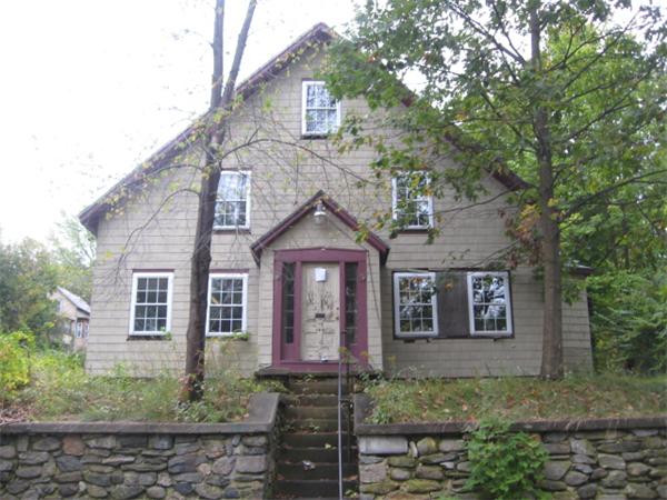 a front view of a house with garden