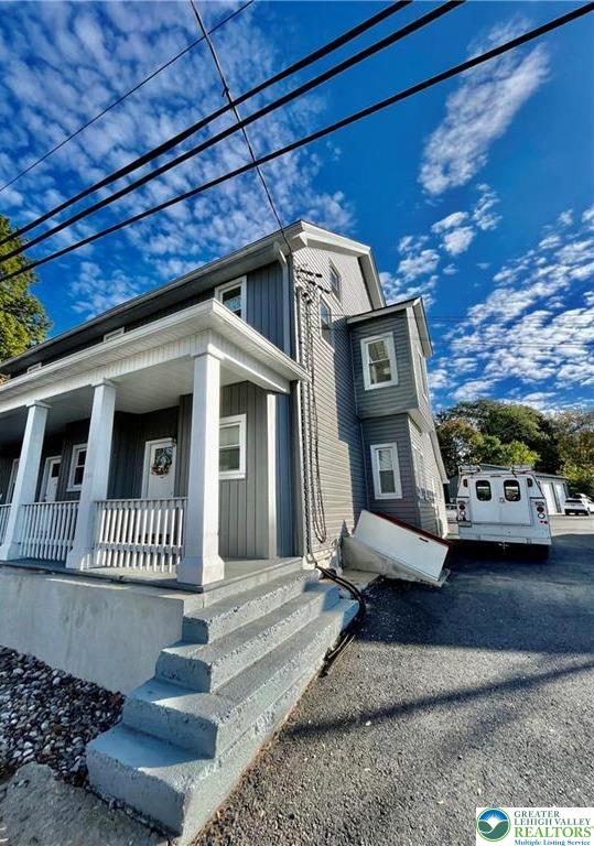 a view of a house with a bench