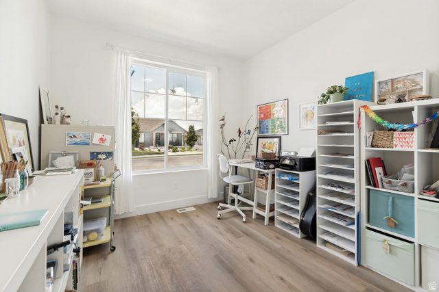 683 Kings Landing Tooele, UT 84074 - Photo 29 of 39 Bright room featuring wood-finish flooring, white walls, and a large window with white trim