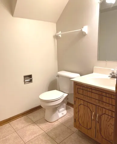a bathroom with a toilet sink and vanity