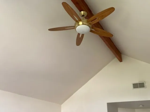 a view of a room with a ceiling fan