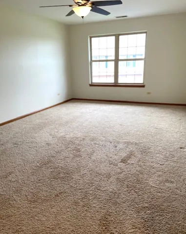 an empty room with a empty space and windows