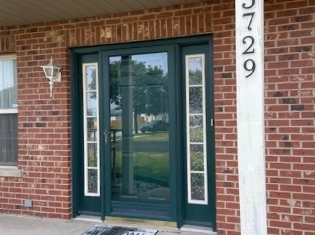 a view of a brick house with a glass door