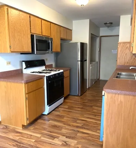a kitchen with a refrigerator stove and microwave