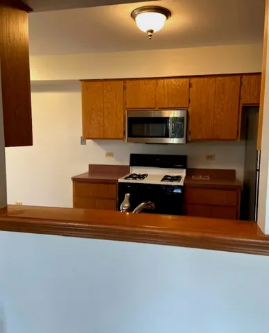 a kitchen with stainless steel appliances a microwave and a sink