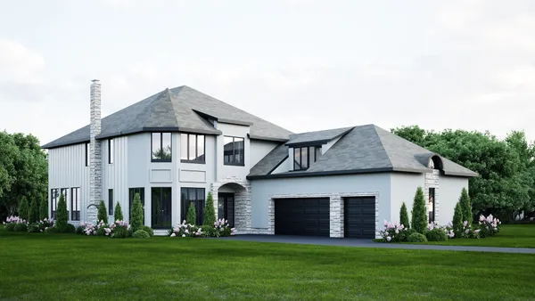 a front view of a house with a garden and yard