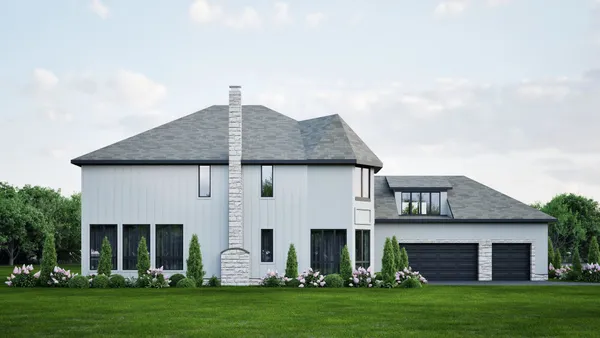 a front view of a house with a garden and yard