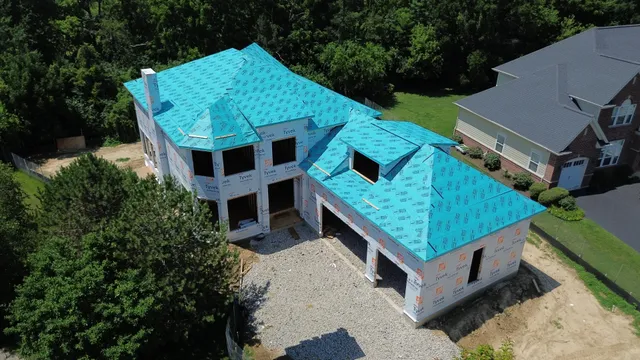 an aerial view of a house with a yard and balcony