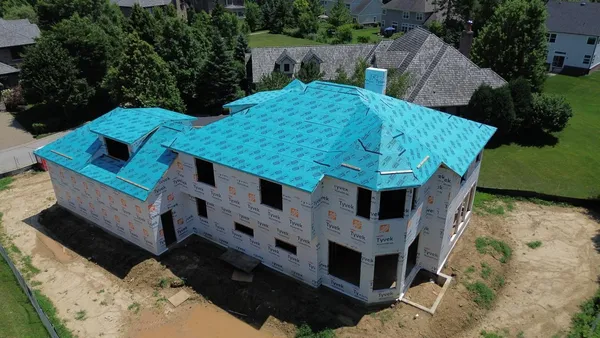 an aerial view of a house with balcony and trees