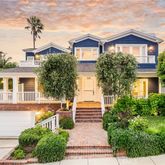a front view of a house with a yard and trees
