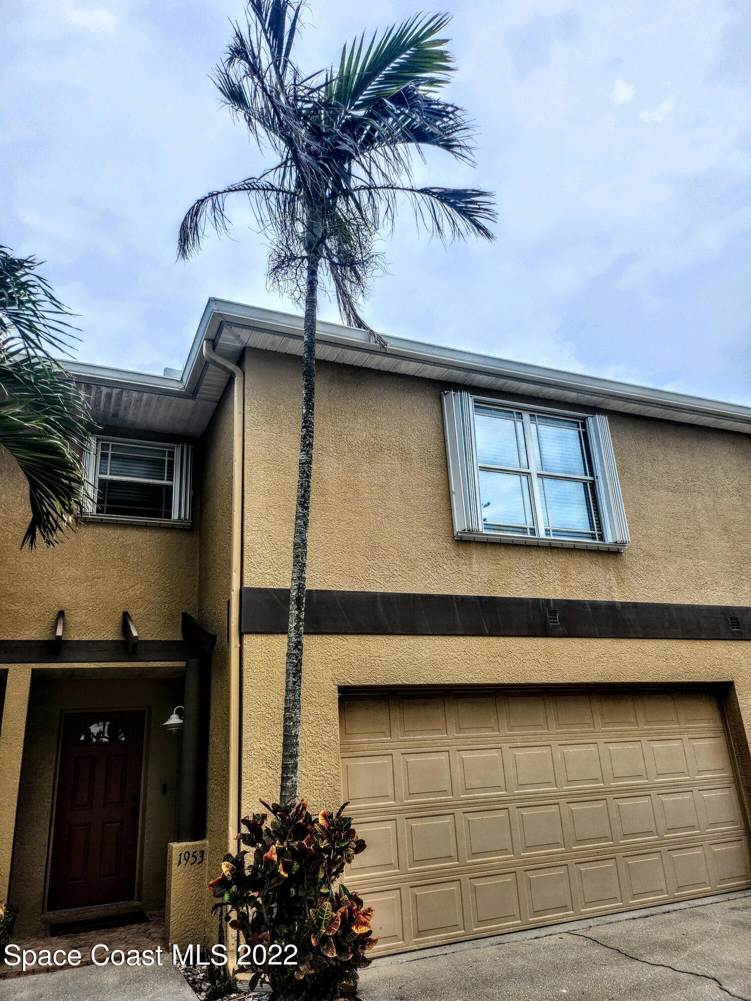 1953 Cato Court, Unit 6 Indialantic, FL 32903 - Photo 1 of 18 a potted plant sitting on the roof of a house