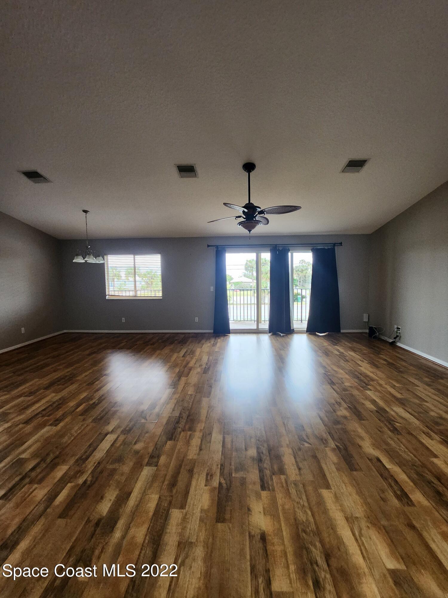 1953 Cato Court, Unit 6 Indialantic, FL 32903 - Photo 4 of 18 a view of wooden floor and windows in a room