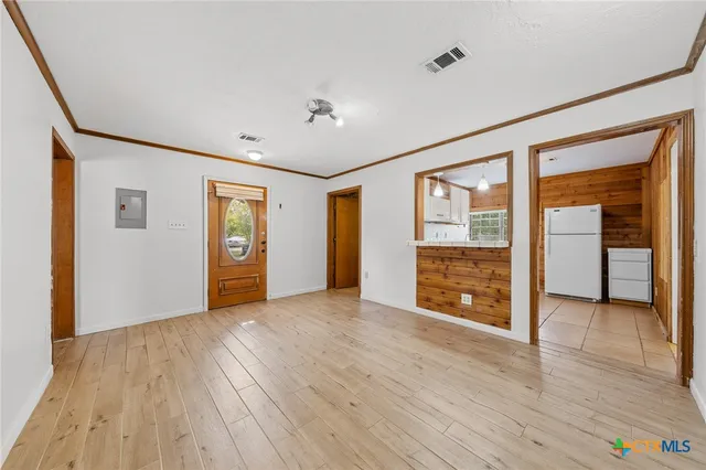 wooden floor in an empty room with a window