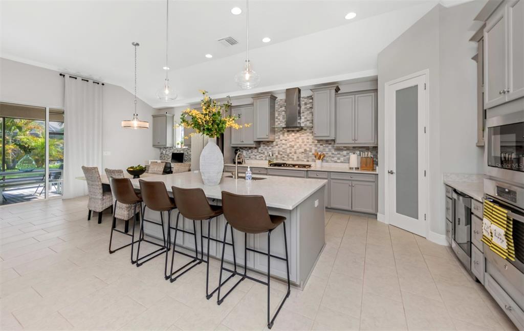 6916 Neopolitan Court Apollo Beach, FL 33572 - Photo 12 of 43 a large kitchen with a table and chairs in it